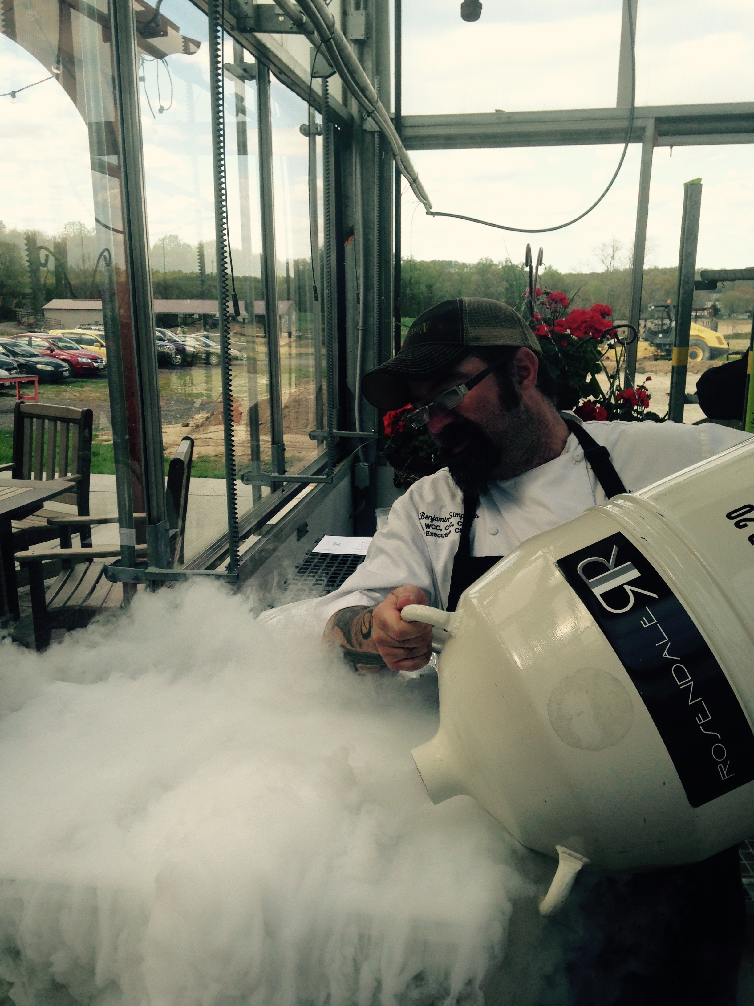 Chef Ben Simpkins working with liquid nitrogen at an outdoor culinary demonstration
